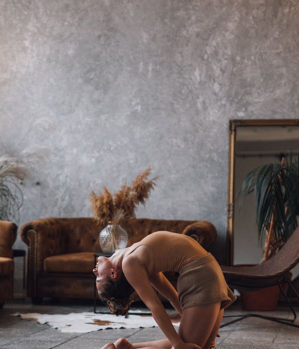 Woman meditating in a serene yoga pose, surrounded by soft, warm light.